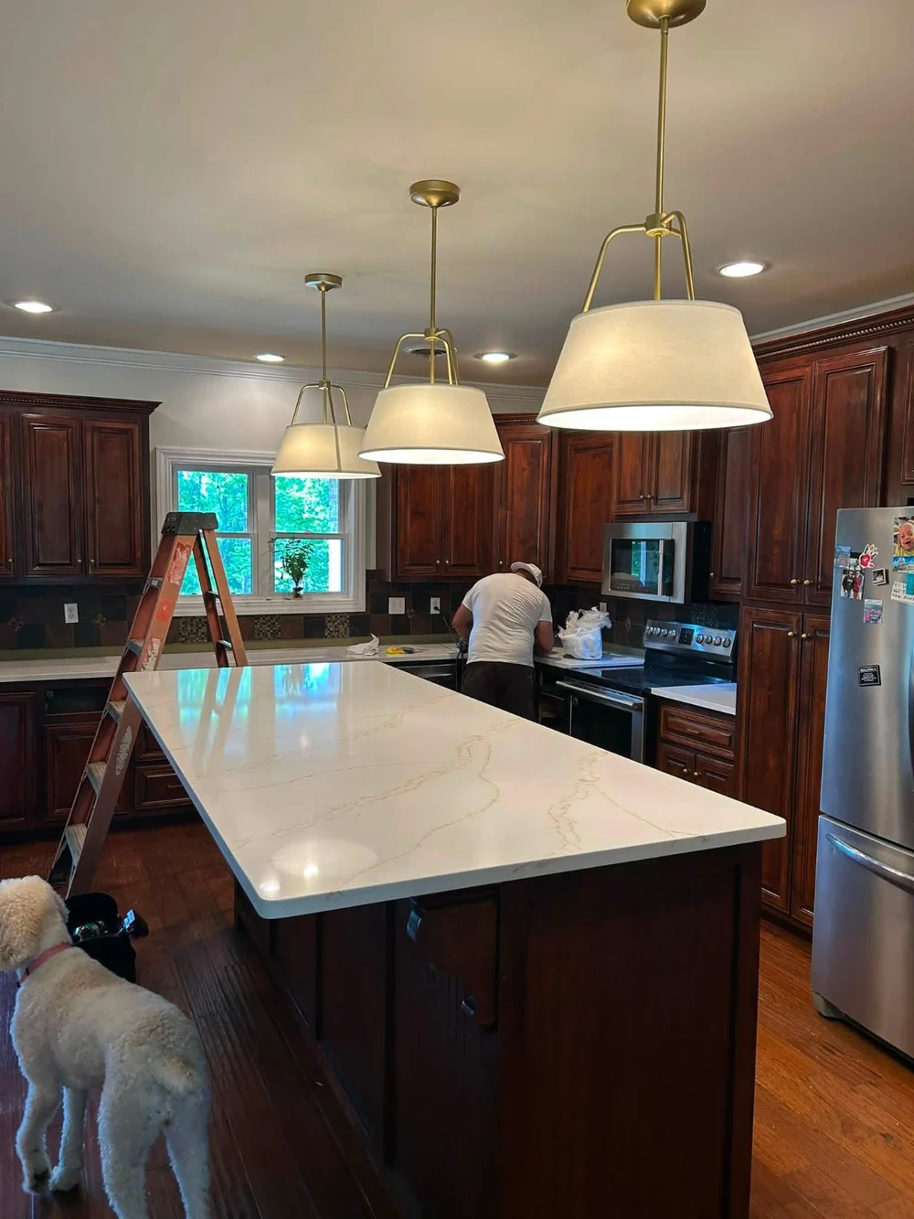 Pendant and recessed lighting above a kitchen island