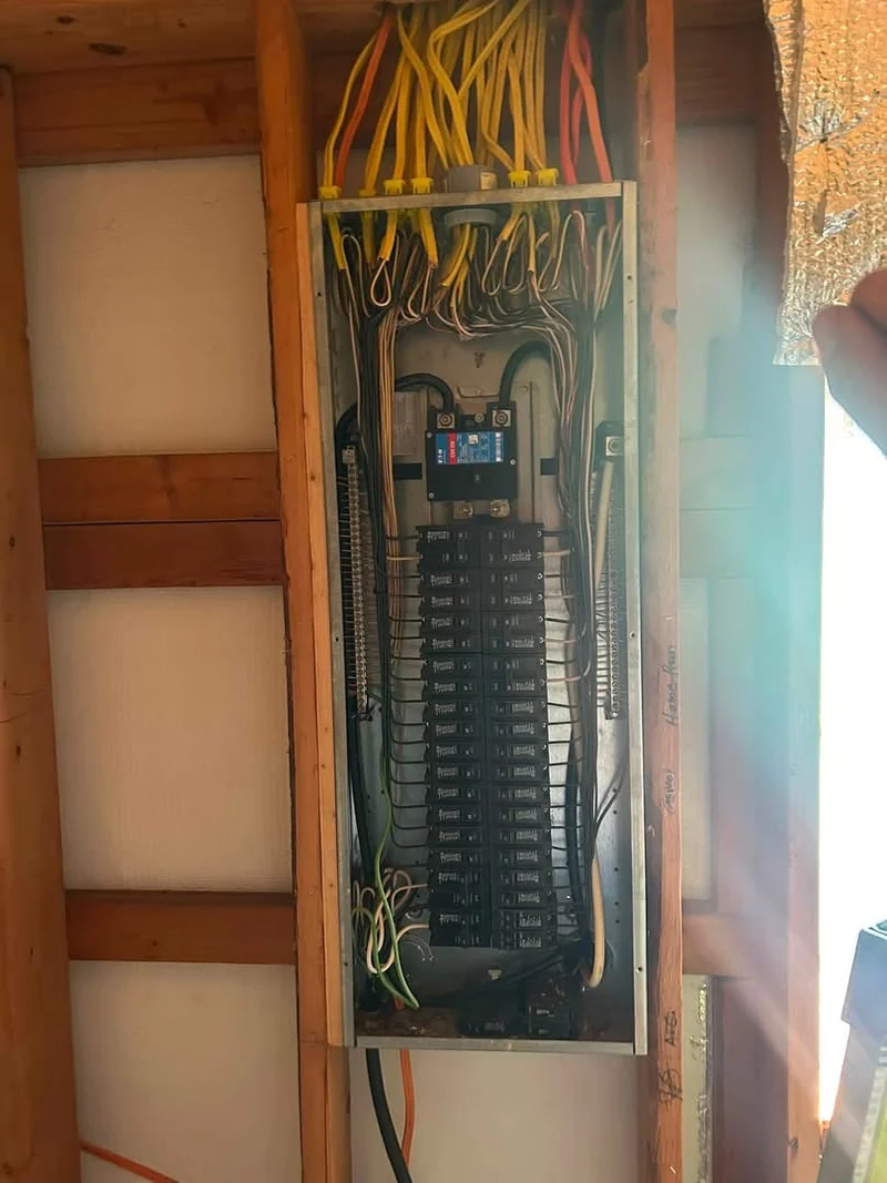 Routed and terminated conductors inside a residential electrical panel